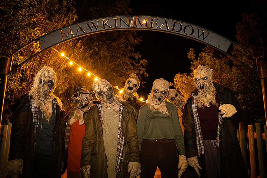 People dressed as ghouls in Mawkin Meadow, part of The Crows, Thorpe Park Fright Nights 2025