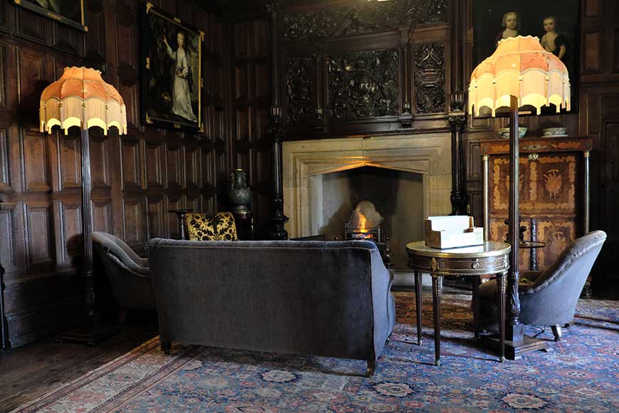 The Queen’s Room at Sizergh Castle showing oak panelling, stone Tudor fireplace, carved oak overmantel