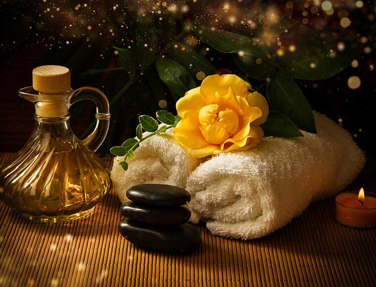 Massage oil, hot stones, and towels