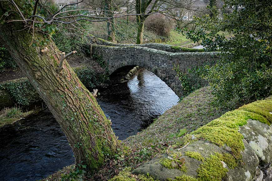 Stone bridge over Clapham Beck on a winter day at Ingleborough Yorkshire UK