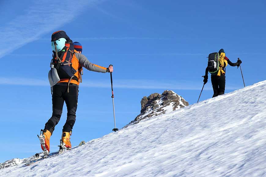 2 people mountain hiking on skis 

Travel Insurance article