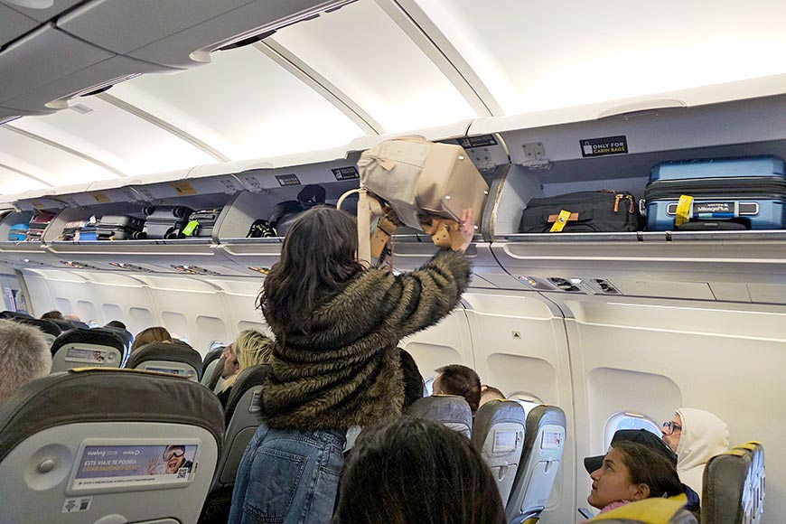 Passenger placing bag in overhead locker on Airbus A 319 aeroplane.

Hand luggage rules 2026