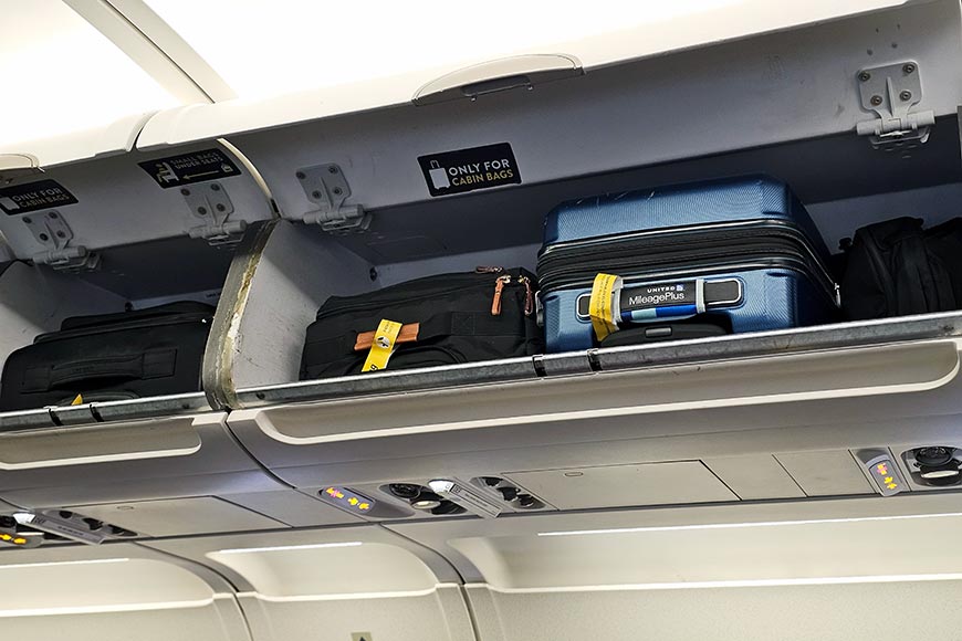 Suitcases in overhead luggage lockers on Vueling aeroplane.

Hand luggage rules 2026