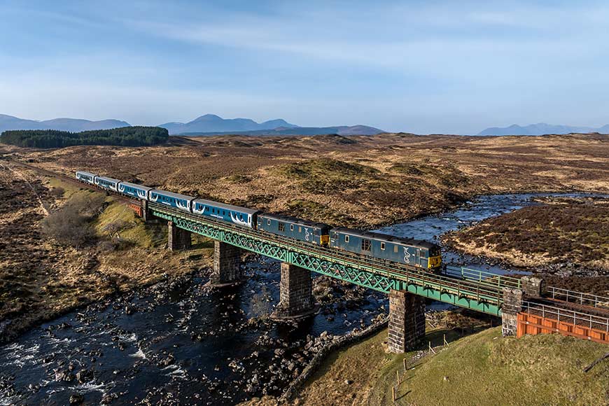 Caledonian Sleeper 1Y11 London Euston - Edinburgh - Fort William hauled by 73 967 and 73 968 crosses the Gaur Viaduct between Bridge of Orchy and Rannoch, Scotland, UK.