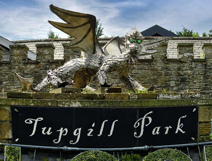 Large stainless steel dragon sculpture guarding the entrance to The Forbidden Corner