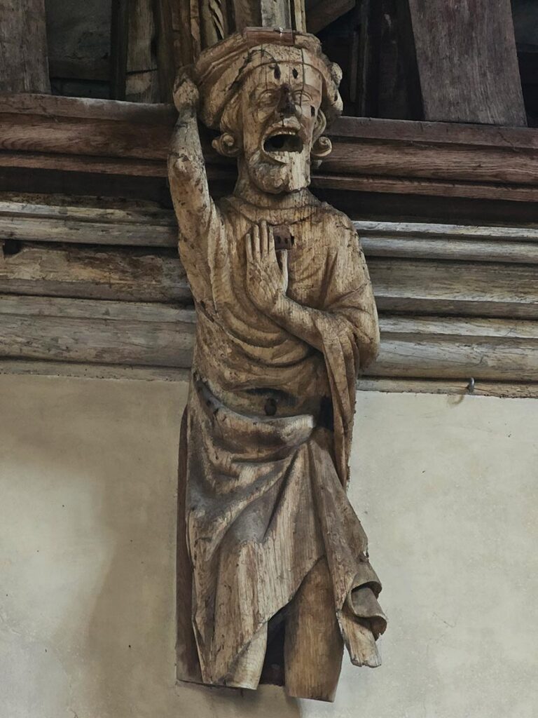 Carved wooden corbel figure inside the medieval Baron's Hall at Penshurst Place in Kent