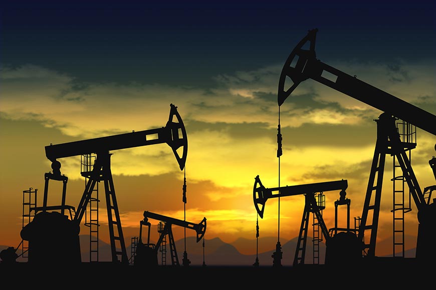 Silhouettes of oil pump jacks, also known as nodding donkeys, at sunset.